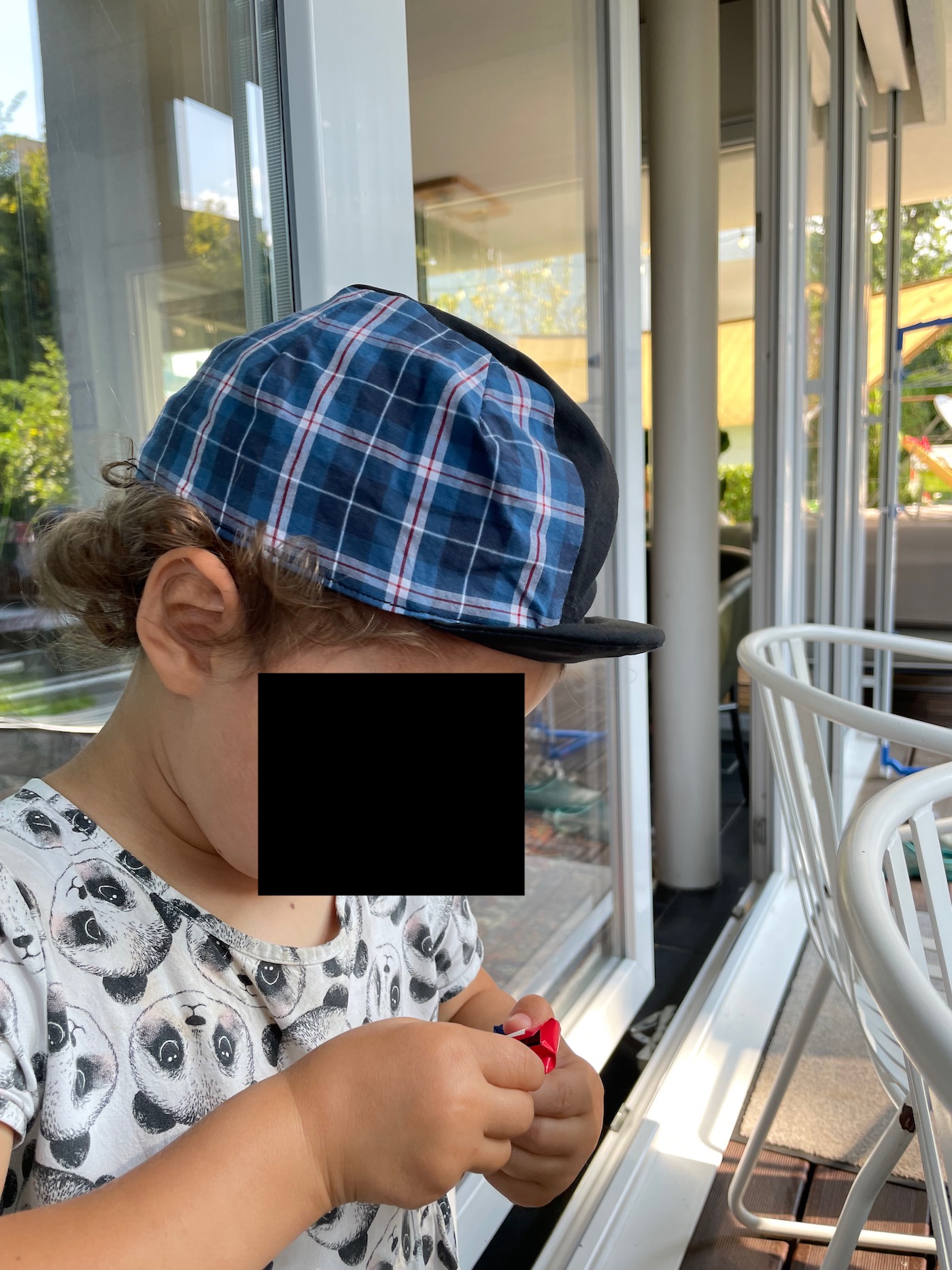 The birthday kid enjoying chocolate and a new cap The birthday kid enjoying chocolate and a new cap